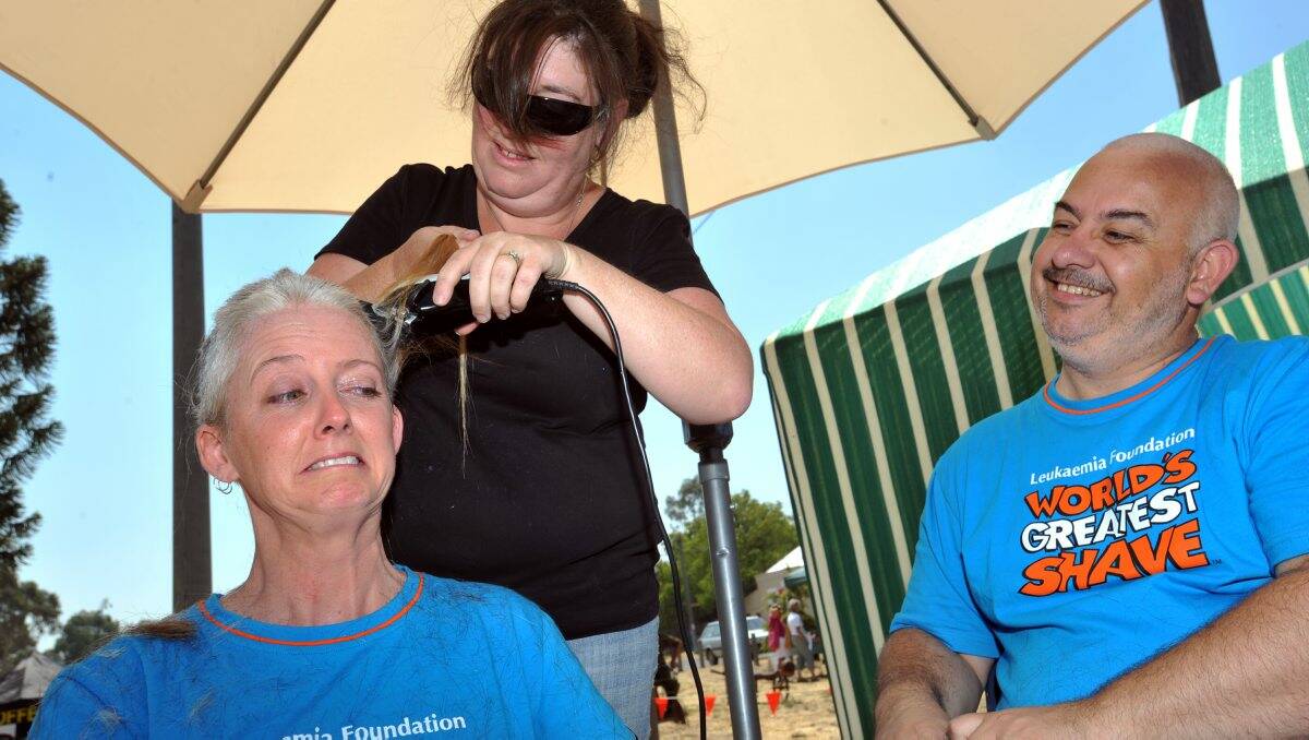 LEFT: Michelle and Garry losing their locks at the Harcourt Community Market yesterday to raise funds for the Leukaemia Foundation’s World’s Greatest Shave. Picture: Julie Hough
