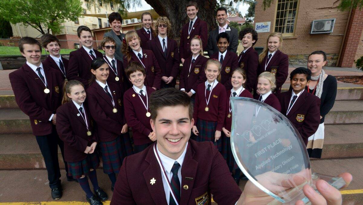 FINALS-BOUND: Girton’s Tournament of Minds captain Jacob Kaye and the school’s other competitors with one of the three trophies that was won by the school. Also pictured are teachers Viv Bath, Nigel Vernon and Tabatha Peters. Picture: JIM ALDERSEY