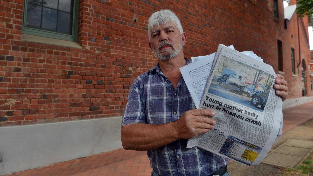 FED UP: Tony Cutting with the petition and a copy of the Addy’s report of a crash on the Elmore-Raywood Road which killed a young woman. Picture: BRENDAN McCARTHY
