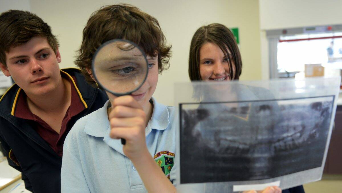 Close up: From left, Cody Schepers, Joseph McCormick and Stephanie Bitter take on the role of forensic investigators as part of a CSIRO Forensic Frenzy workshop. Picture: Brendan McCarthy