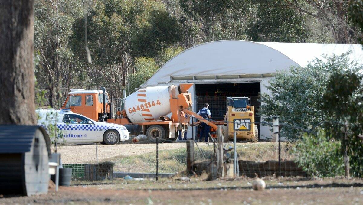 DISCOVERY: Police and DPI inspectors at the Woodvale chicken farm, which is being investigated after about 5000 roosters starved to death. Picture: JIM ALDERSEY