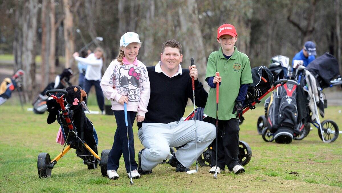 DRIVING FORCE: Neangar Park Golf Club's professional Erik Hendrix with Jazy, 7, and Tom Roberts, 8. Picture: JIM ALDERSEY