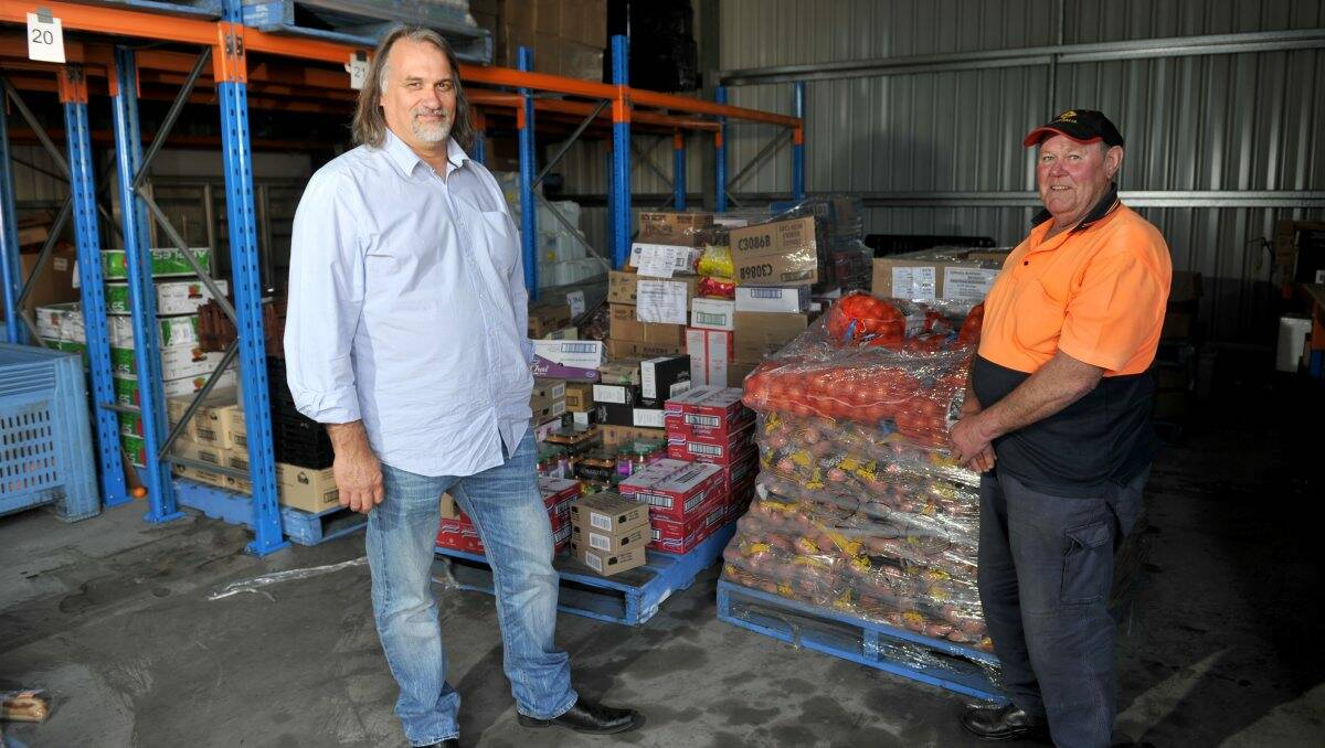 Waste not, want not: Foodbank Victoria’s Brien Baxter and volunteer Mick Crowley. Picture: JODIE DONNELLAN