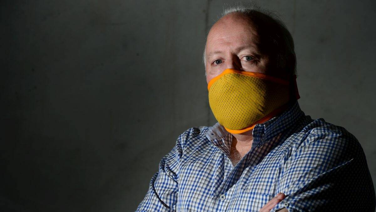 CLEVER DESIGN: Inventor Mike Taylor shows the Fair Air mask he is trying to get rolled out  to CFA brigades in Victoria. Picture: JIM ALDERSEY