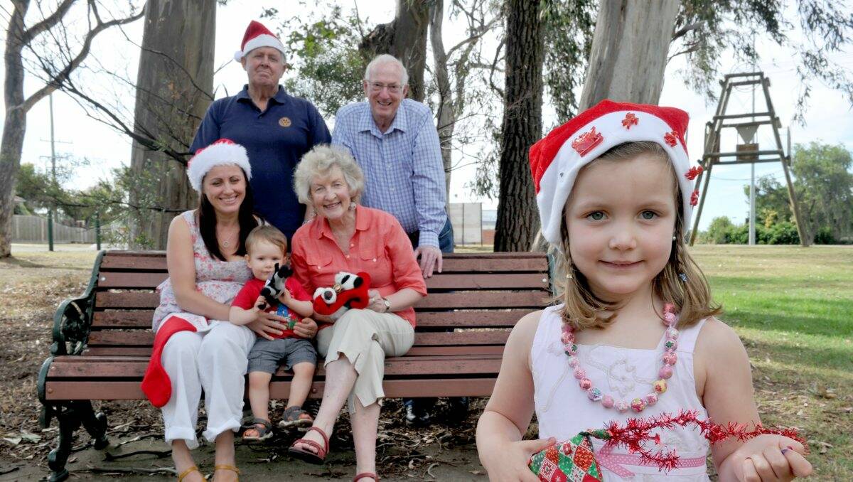 CAN'T WAIT: Neil Draffin, Graeme Shellew and Lynne Cooper from Rotary Club of Bendigo-Strathdale with Yllka Wickham and her children Lorenzo, 1, and Indiana, 4, (in front) are all set for the community carols. Picture: JODIE DONNELLAN