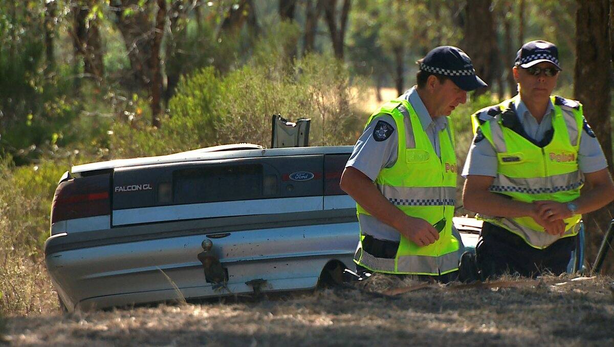 Probe: Police inspect the scene of Saturday’s crash. Picture: Apex Imagery