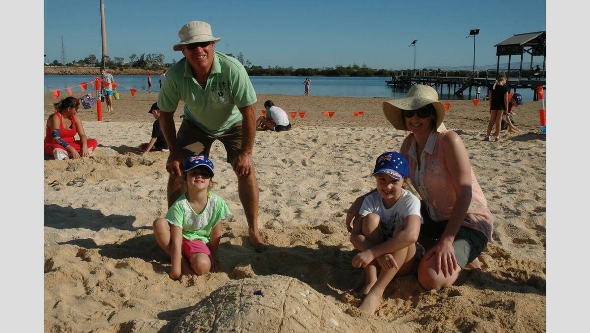 Jeff Helmers, back, left and Renee Williams were snapped with Maelie and Amity Williams after using their creative skills to make a turtle in the sand.