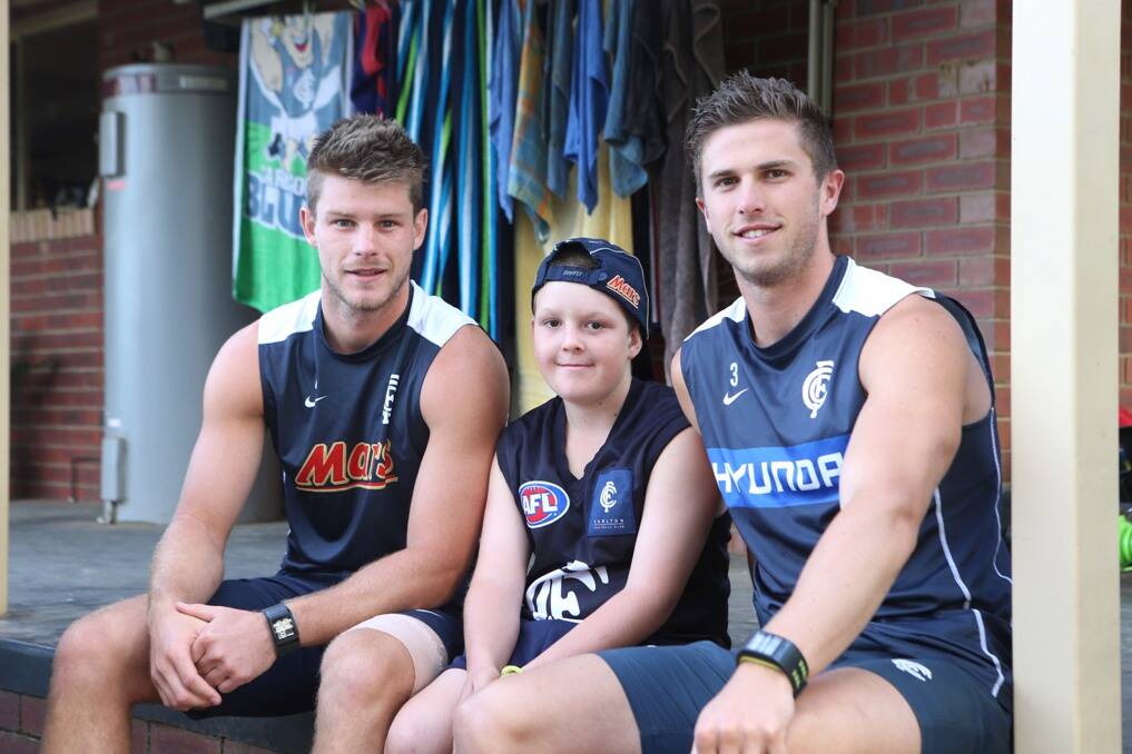 Competition winner Jacob Boyd, 11, from Maiden Gully with Carlton stars Marc Murphy and Bryce Gibbs. 