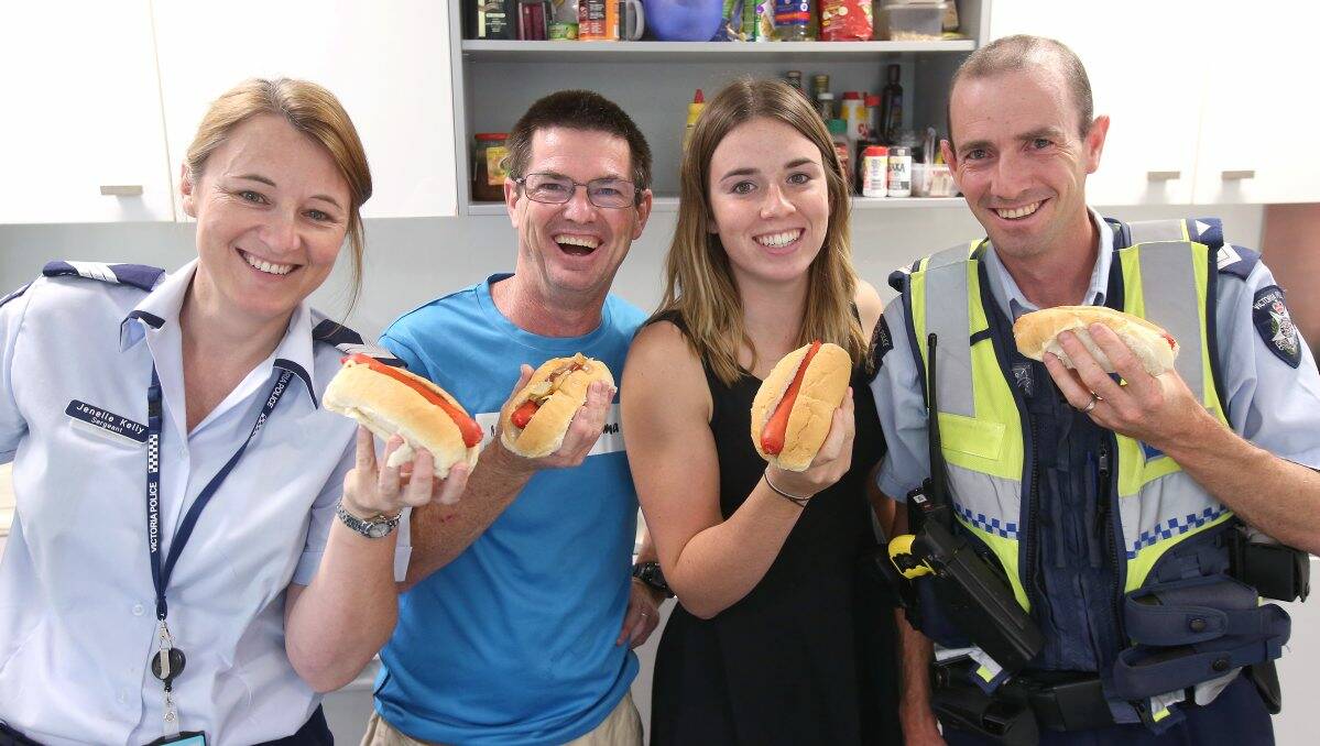 TASTY: Oxfam Trailwalker competitors Sergeant Jenelle Kelly, Eric Baker and Emily Kelly with Senior Constable Ross McPhee. Picture: PETER WEAVING 