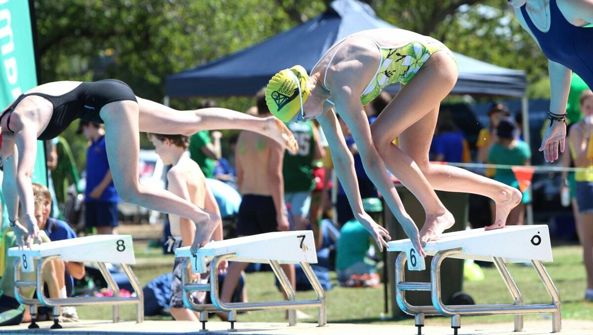 SUPERB FORM: Hannah Jordan, yellow cap, at the start of an under-16 girls' final at BSE's swimming championships at Bendigo Aquatic Centre. Picture: PETER WEAVING