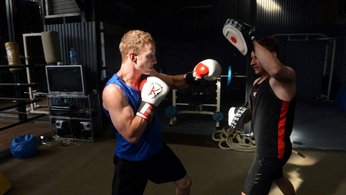 WORKOUT: Mitch Smith strikes the pads held by trainer Danniel Burton during a training session at The Hit Factory in Golden Square. Picture: BRENDAN McCARTHY 