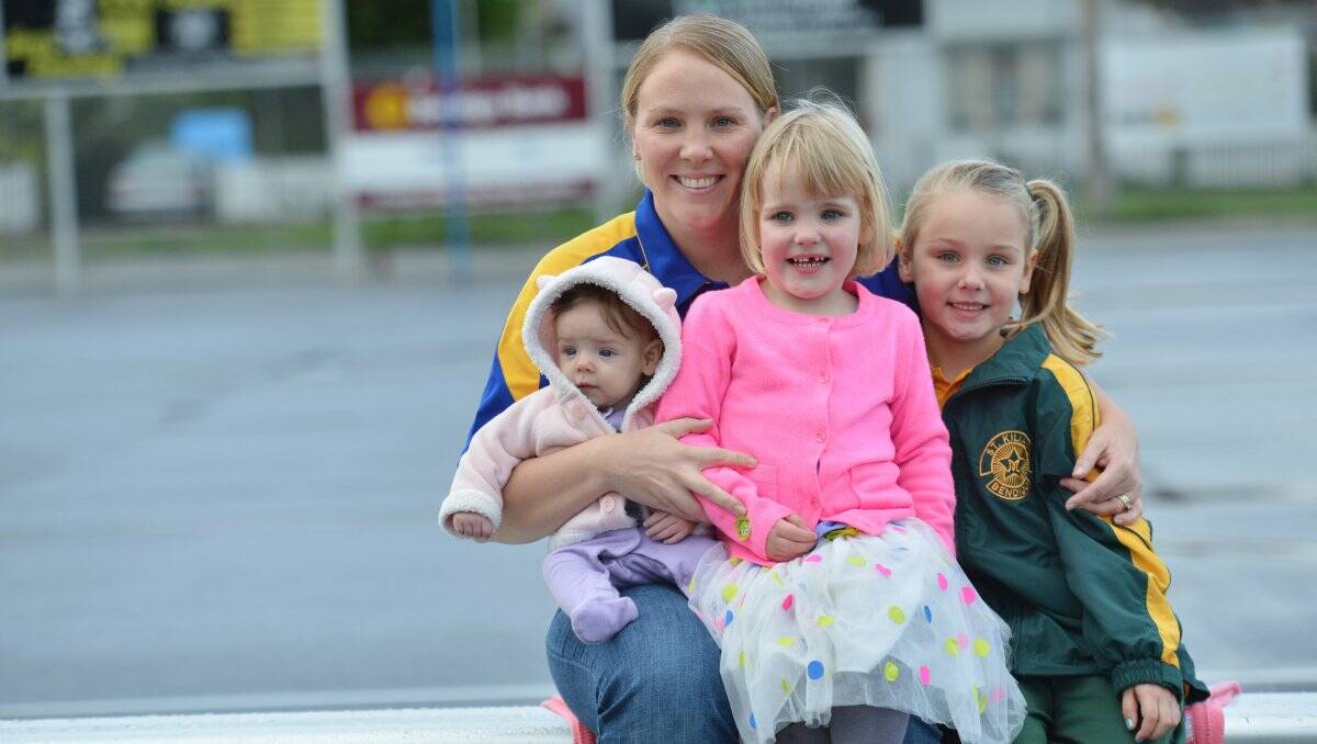 TIME OUTt: Golden Square 200-game veteran Belinda Pinner with three of her biggest fans, children Ivy, Neve and Macey. Picture: BRENDAN McCARTHY
