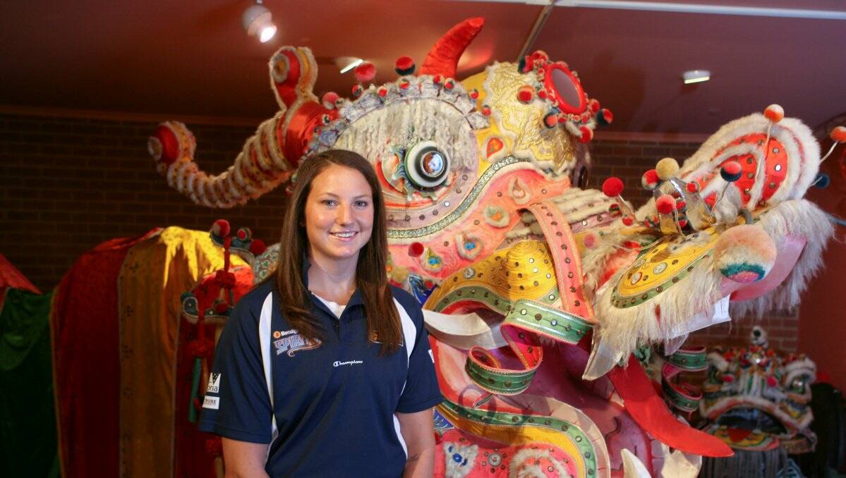 cross-cultures: Bendigo Spirit forward Kelsey Griffin meets Sun Loong at the Golden Dragon Museum. The local Chinese influence was one of the features the US import had heard about the city before she arrived here. Picture: PETER WEAVING 