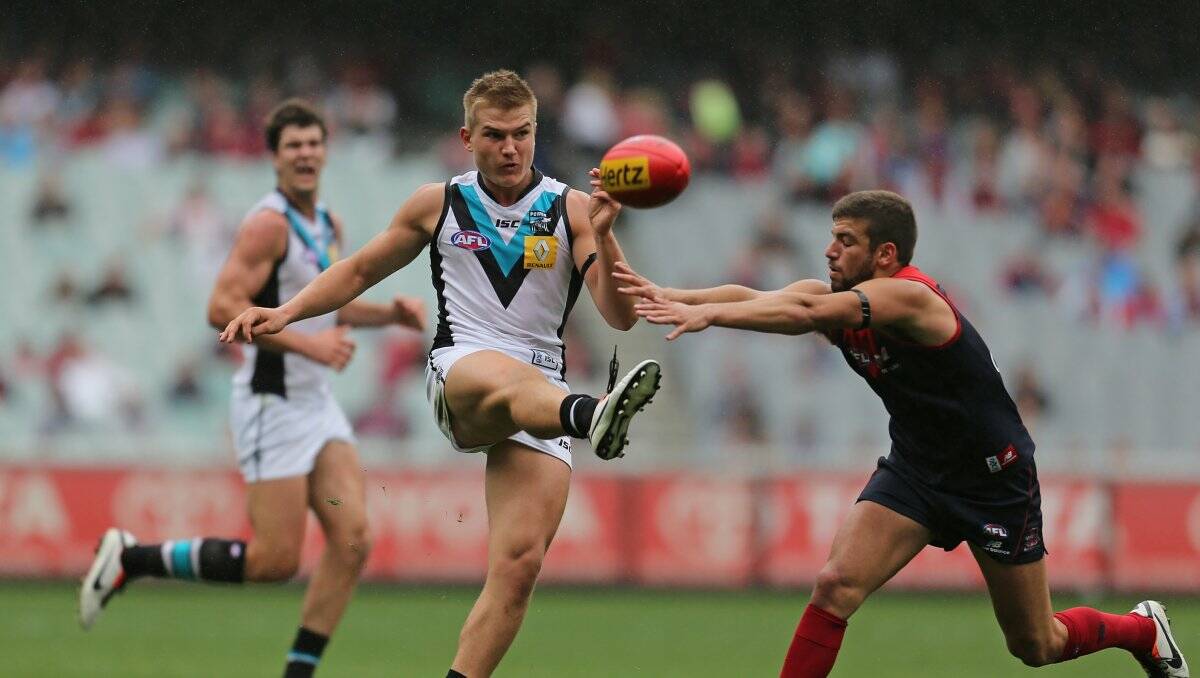 ALL CLASS: Ollie Wines from Echuca gets a kick away in his AFL debut for Port Adelaide against Melbourne yesterday. Picture: GETTY IMAGES 