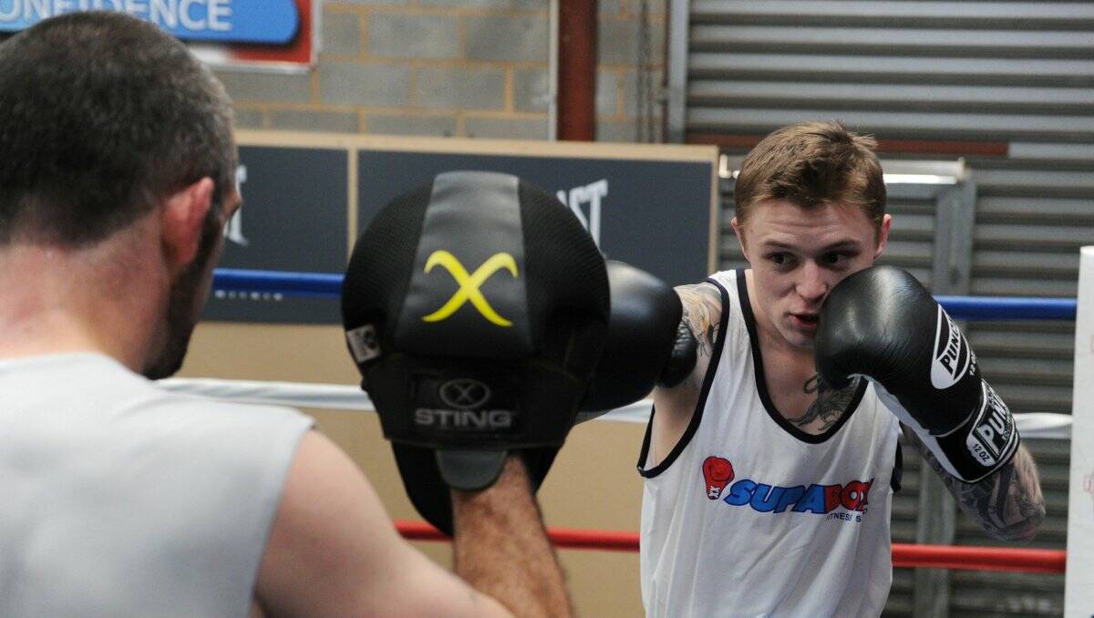 WARMING UP: Danny Taggert strikes the pads held by Lynden Hosking during training at SupaBox in Bendigo. Picture: PETER WEAVING 