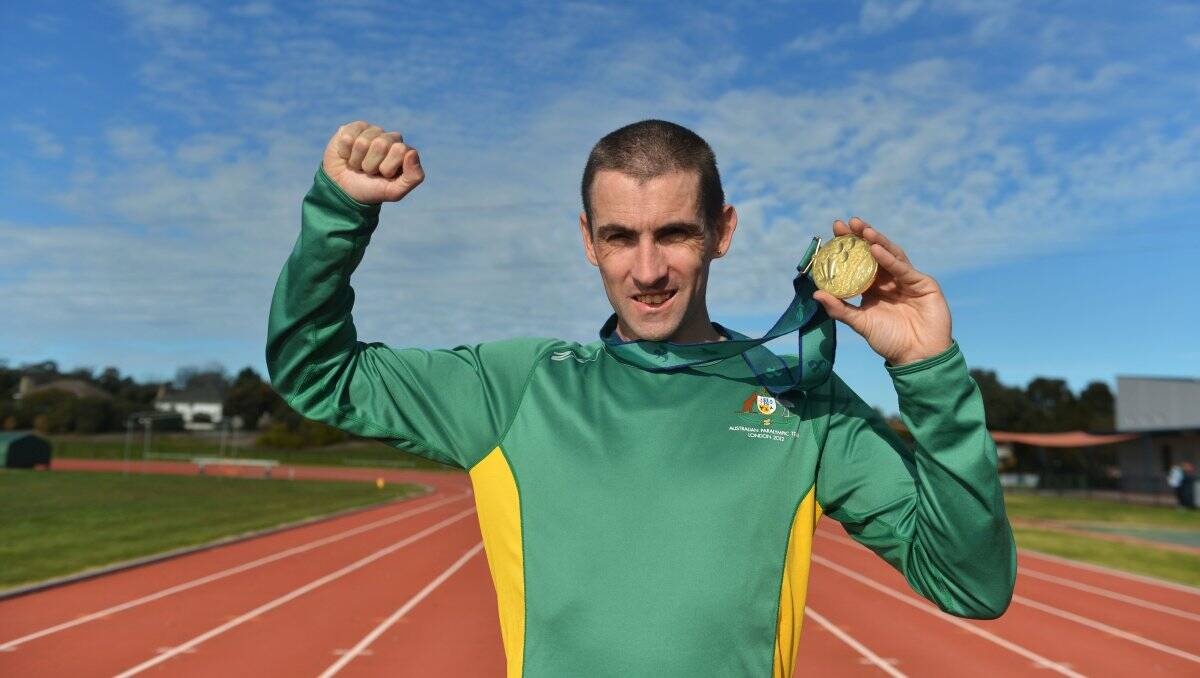 SPRINT STAR: Tim Sullivan holds the first of the 10 gold medals he won in track events in his Paralympics campaigns. Picture: BRENDAN McCARTHY