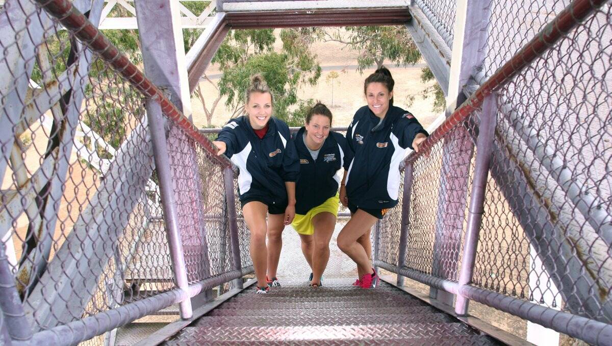 LONG WAY TO THE TOP: Bendigo Spirit team-mates Maddie Garrick, Kelsey Griffin and Renae Camino climb the Rosalind Park lookout. Picture: PETER WEAVING 