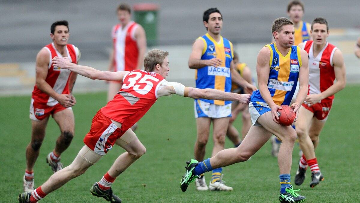 charge: Golden Square defender Dale Young takes on the Bloods. Picture: JULIE HOUGH
