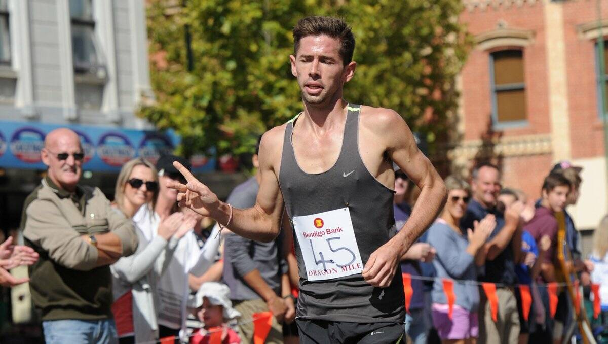 NUMBER ONE: Bendigo's Brady Threlfall sprints to victory in yesterday's Bendigo Bank Dragon Mile run before the gala parade. Picture: JODIE DONNELLAN 
