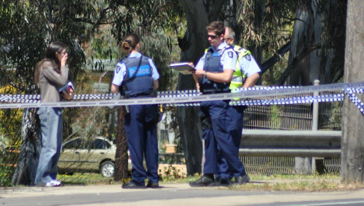 Police talk to a woman outside the home where the baby was injured. Picture: ROB DURSTON
