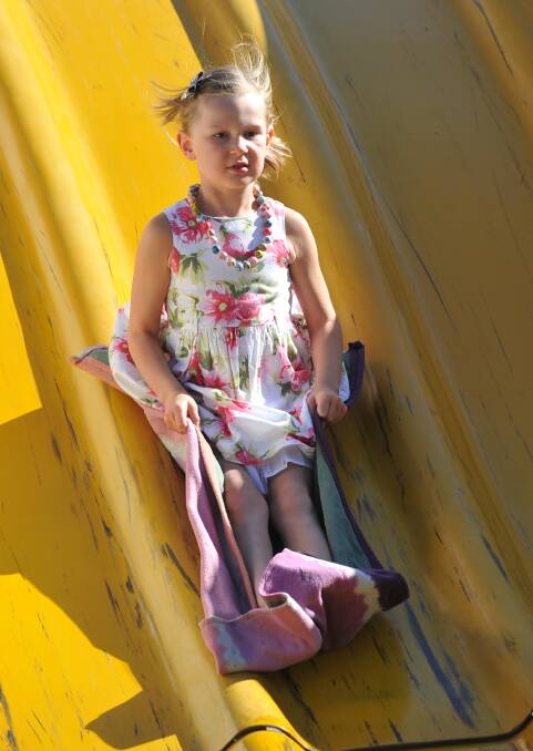 Grace Robertson, 5, on the giant slide at the Wagga Australia Day breakfast and citizenship ceremony. Picture: Michael Frogley