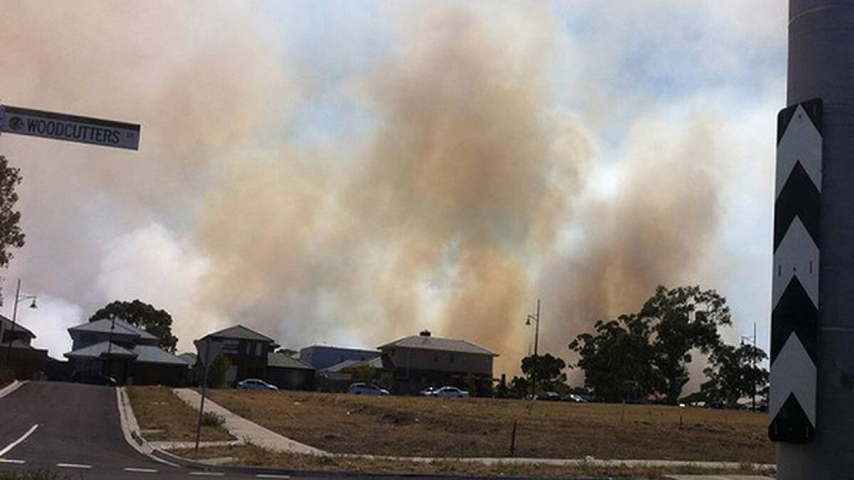 Smoke rises above houses as a reader drives down High Street in Epping about 4pm in this image supplied by The Age reader Tanya. Photo: Supplied