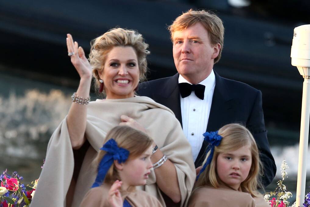 Queen Maxima and King Willem Alexander of The Netherlands with daughters are seen aboard the Kings boat for the water pageant. Photo by Andreas Rentz/Getty Images