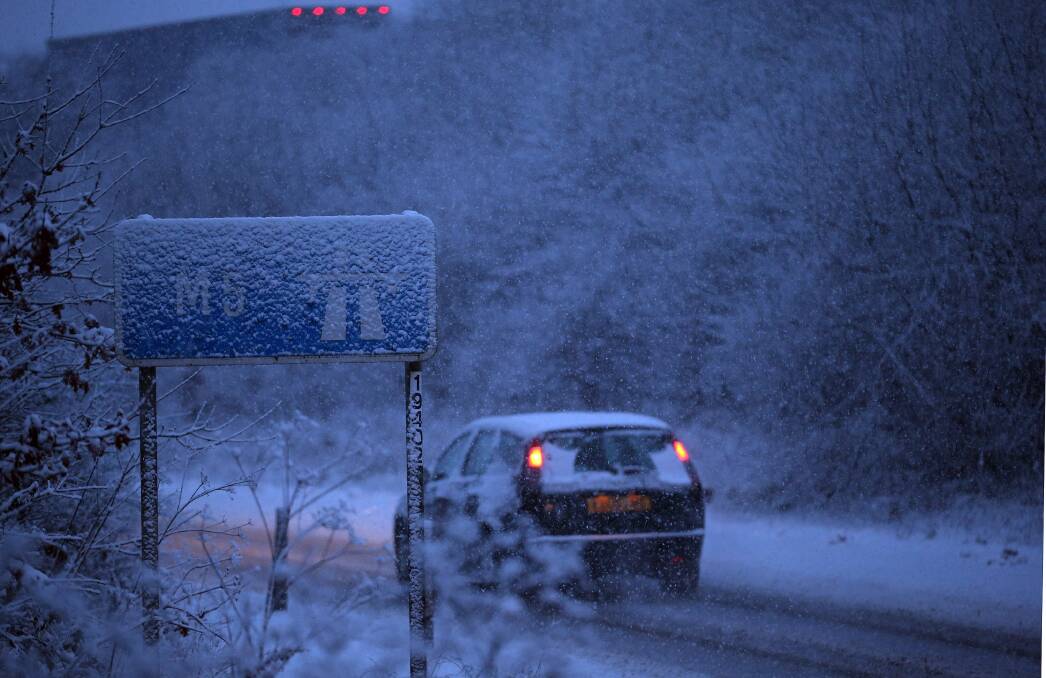 Vehicles make their way around Junction 26 of the M4 motorway as snow falls on January 22, 2013 near Wellington, England. Photo by Matt Cardy/Getty Images