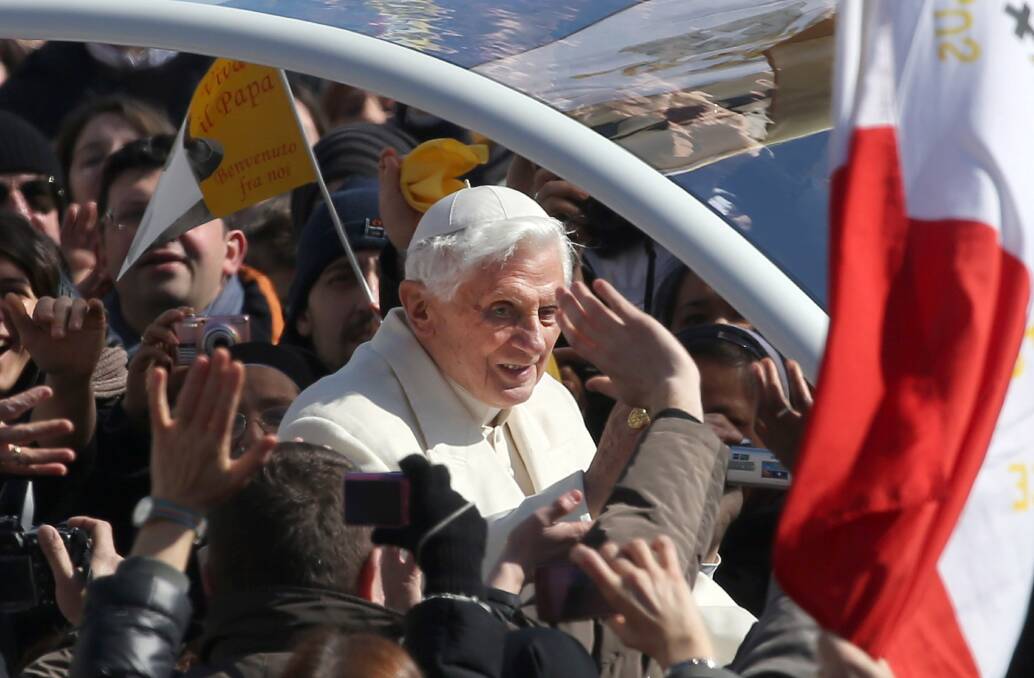 Pope Benedict XVI waves to the faithful as he arrives in St. Peter's Square for his final general audience in Vatican City. Photo by Franco Origlia/Getty Images