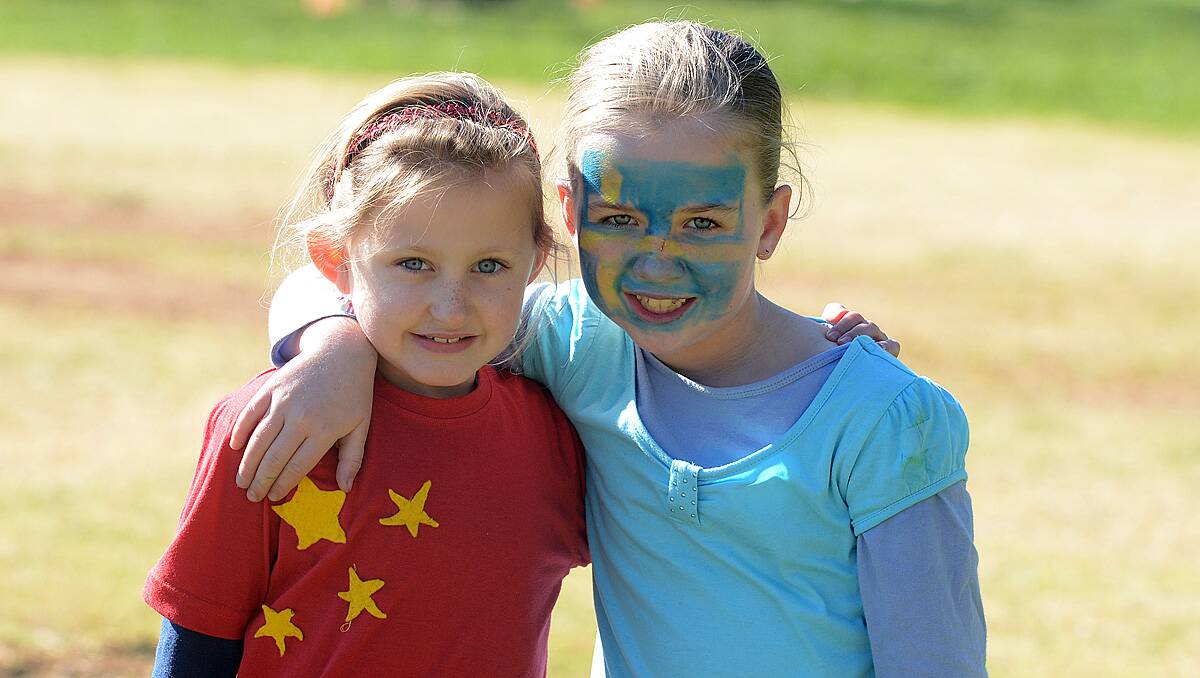 Olivia Smith and Nelly Donnelly from Goornong Primary School dressed up in team colours for the schools mini Olympics. Photo Jim Aldersey