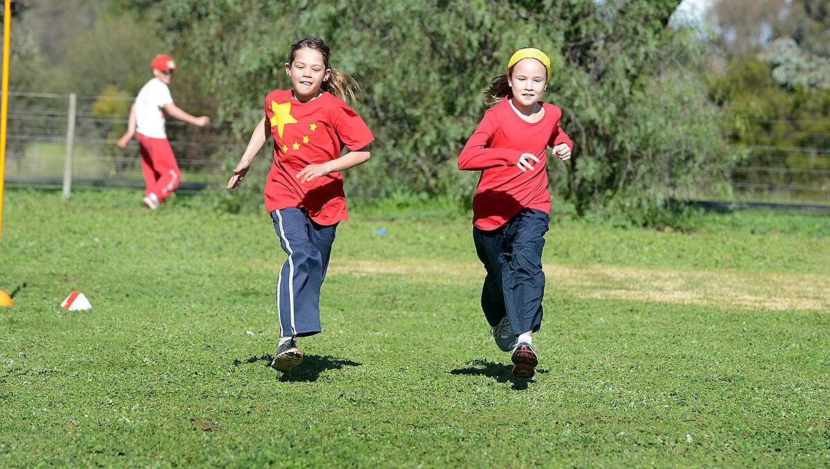Lana Warren grade 3 and Ally Tuohey grade 5 in the running race at Goornong Primary School, dressed up in team colours for the schools mini Olympics. Photo Jim Aldersey