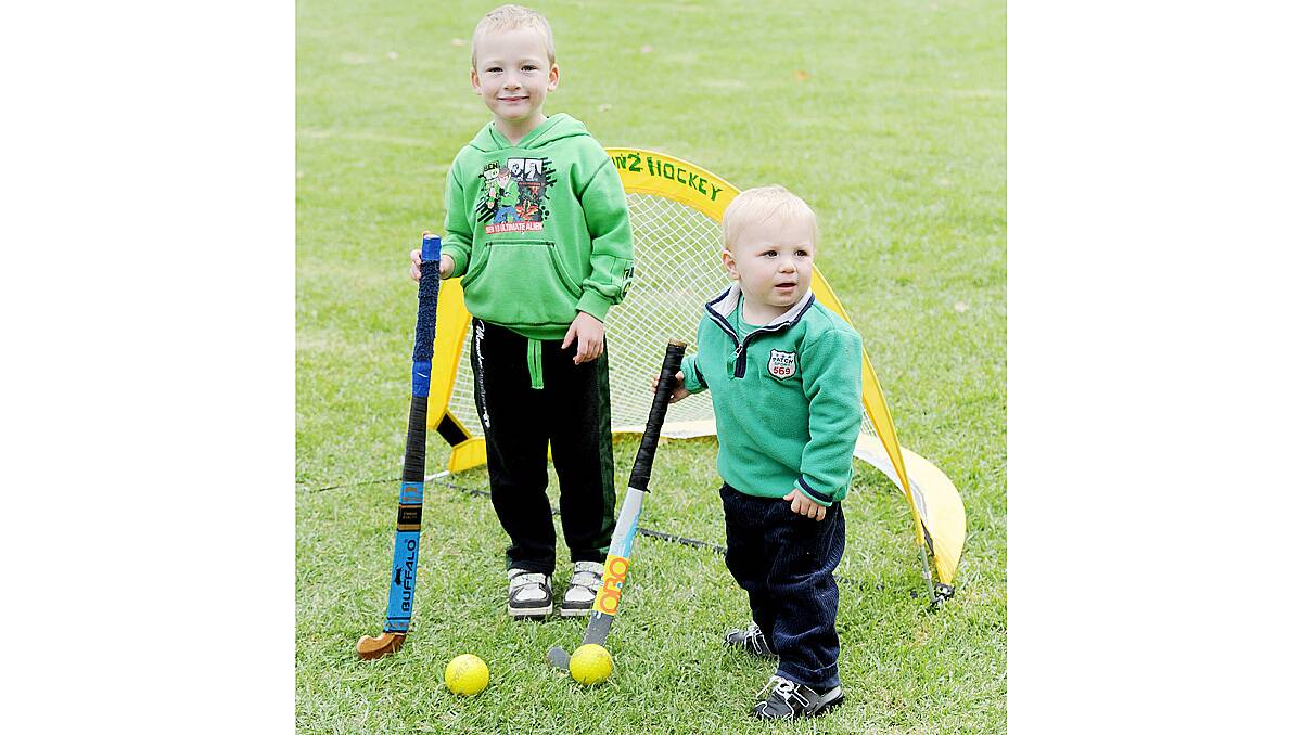 Jacob Yarwood, 5 and Henry Isaacs, 2 have a go at the Eaglehawk Hockey Club's activities at the Dahlia and Arts Festival family fun day. Picture: Jodie Donnellan