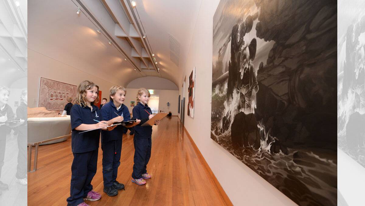 Camp Hill Primary students Sage Greenfield, Otto Ansted and Catie Perrin in the Bendigo Art Gallery looking at Stephen Bush's work titled The Lure of Paris #22. Picture: JIM ALDERSEY