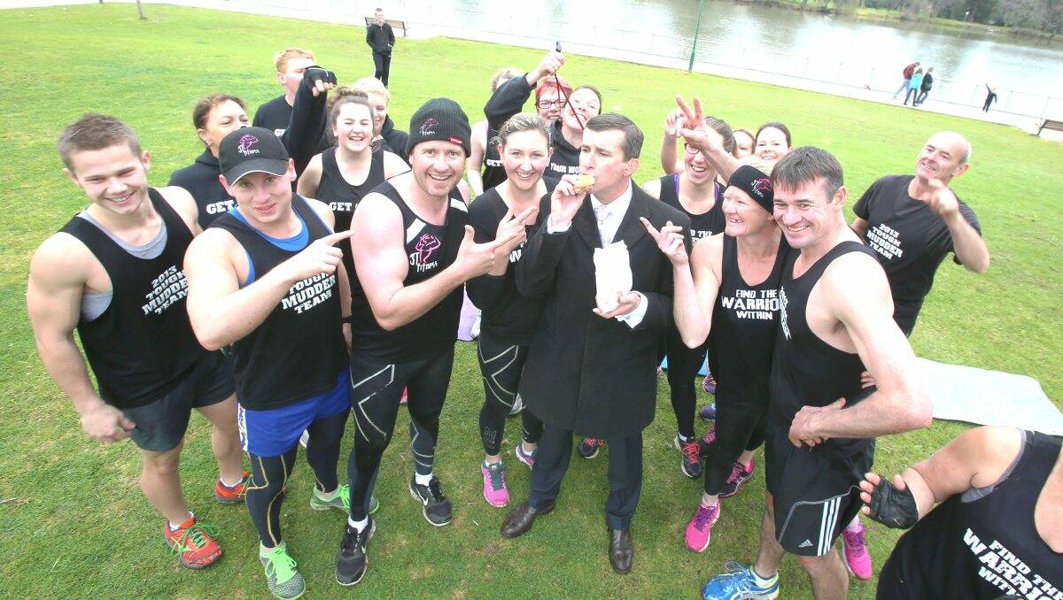 The Today Show's weather man Mike Dalton eating a lakeside donut in Bendigo with the 3T Fitness crew. Picture: Peter Weaving