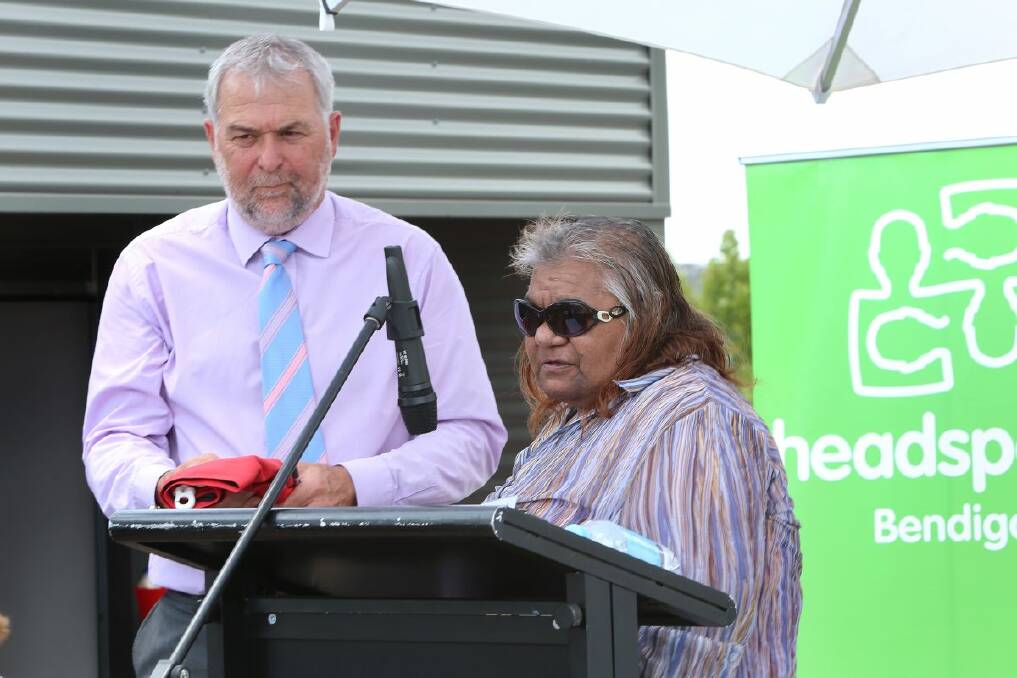 TRADITION: David Pugh accepts the Aboriginal flag from Brenda Kerr. 