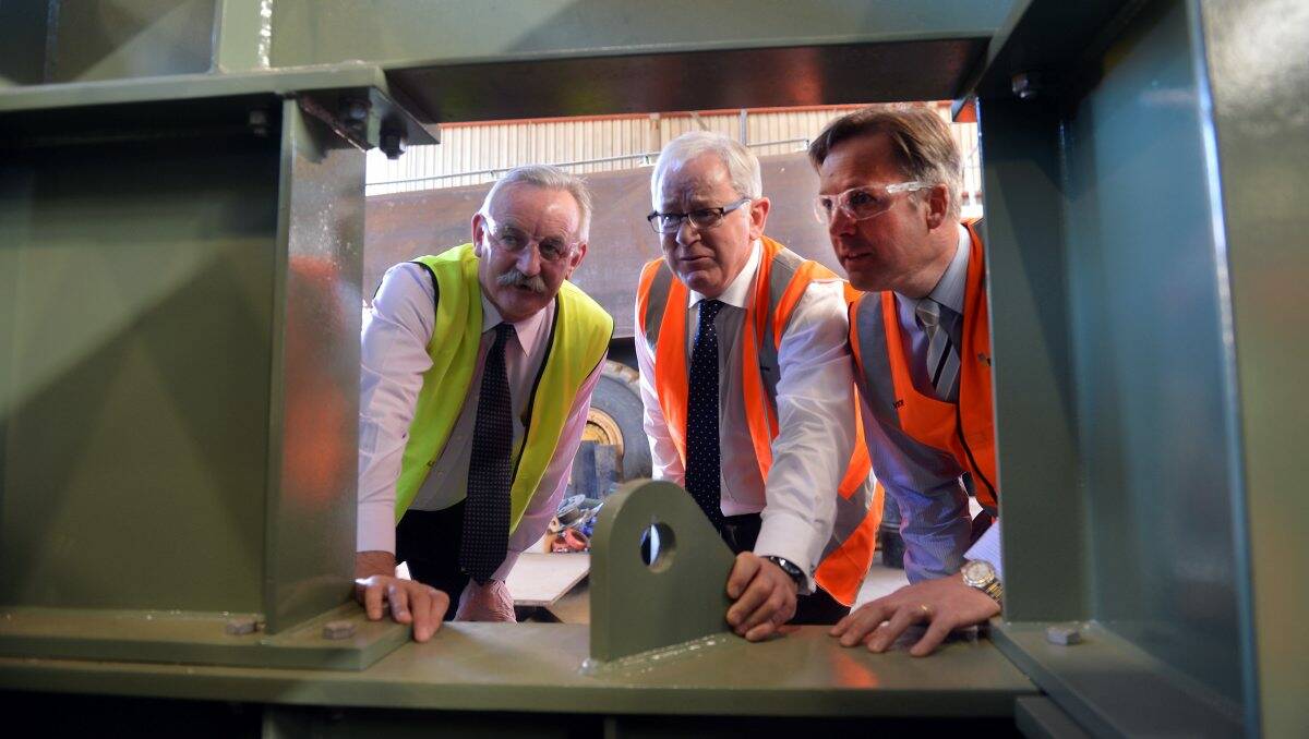 Australian Turntable Company's Paul Chapman with Opposition Finance Minister Andrew Robb and Liberal Candidate Greg Bickley looking over the turntable project. Picture: Brendan McCarthy