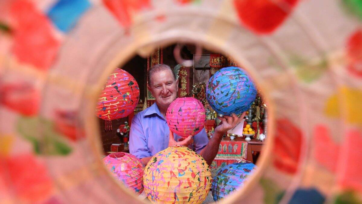 ILLUMINATED: Stan Cue shows off the lanterns on display at Joss House. Picture: PETER WEAVIN