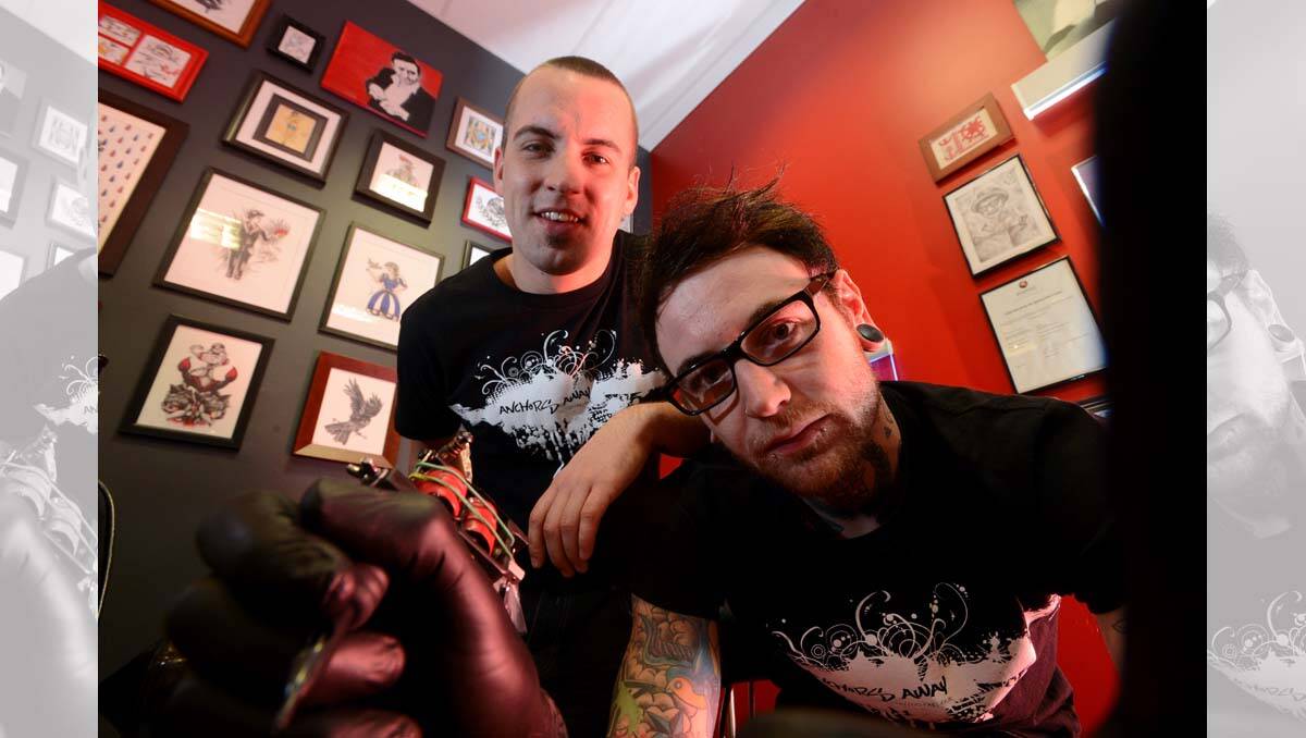 Brothers Josh Kerr and Jarred Boland in their family-owned business Anchors Away Tattoo Parlour. Picture: Jim Aldersey