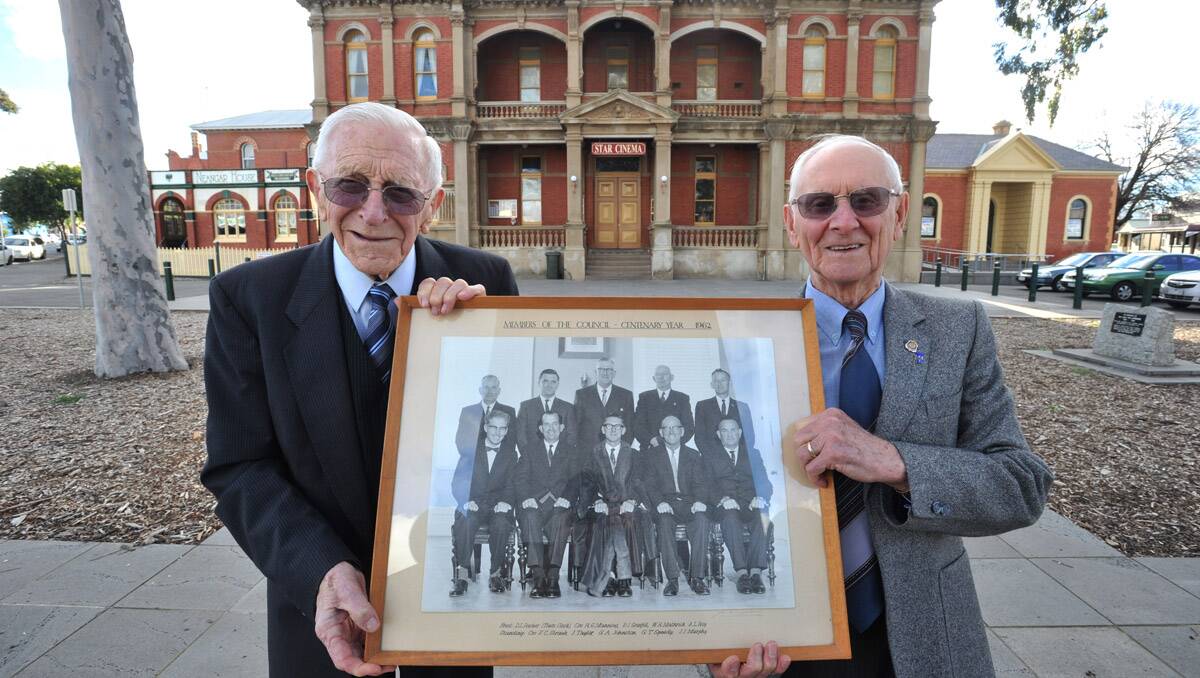 Former Eaglehawk councillors Jack Taylor and Pierce Grenfell with a photo of the council from 1962.