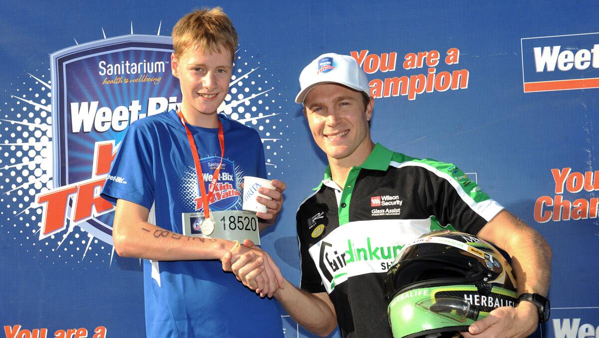 2013 Weet-bix Kids TRYathlon. Age group 11-15. Alexander Evans with V8 supercar driver Karl Reindler. Picture: Julie Hough