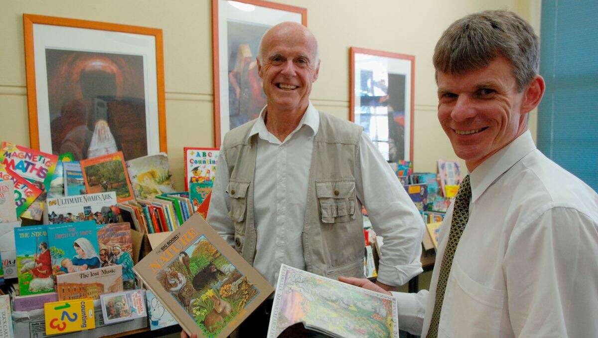 Catholic College principal Darren McGregor is pictured, right, in 2008 with book donations from the college to a school in Sabah, Malaysia. He is pictured with Steve Campbell. Picture: Julie Hough