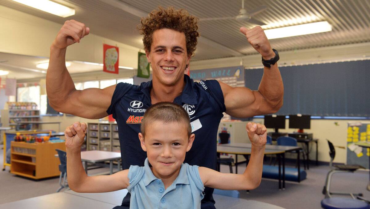 Carlton players visit Lockwood South Primary. Ed Curnow with Yan Feng Ross. Picture: Brendan McCarthy