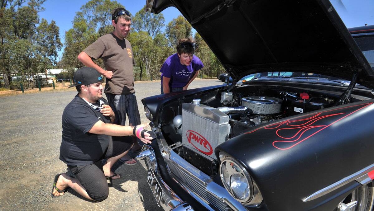 Rhys Watson, from Melbourne, shows off his '56 Chev to Corey Howarth and James Griffiths. Picture: Julie Hough