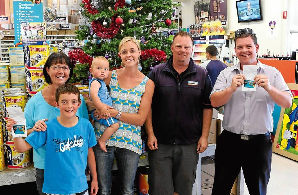 WINNERS: Briohny Mitchell, lucky reader prize winner, holds her son Archer, 1, with mum Margaret Edwards and son Declan, 9. They are pictured with Hume and Iser’s Brenton Bogumil and Christmas Lights competition winner Mick Scanlon. Picture: PETER WEAVING