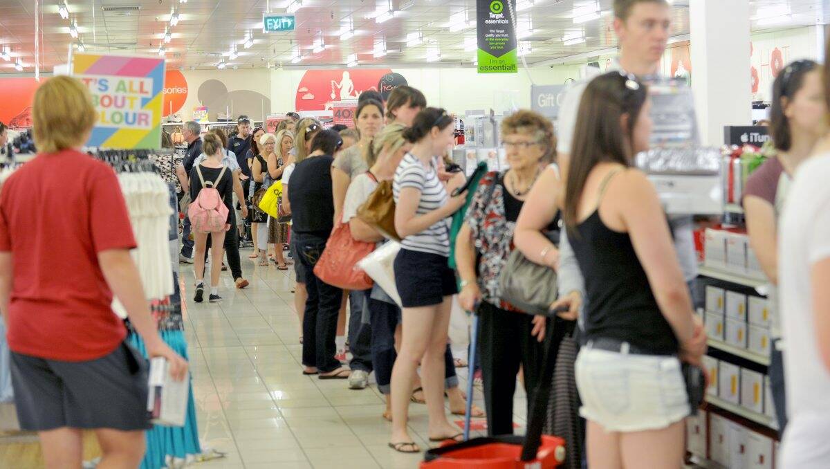 EAGER: Shoppers queue at the registers at Kmart’s Boxing Day sale. Picture: JODIE DONNELLAN
