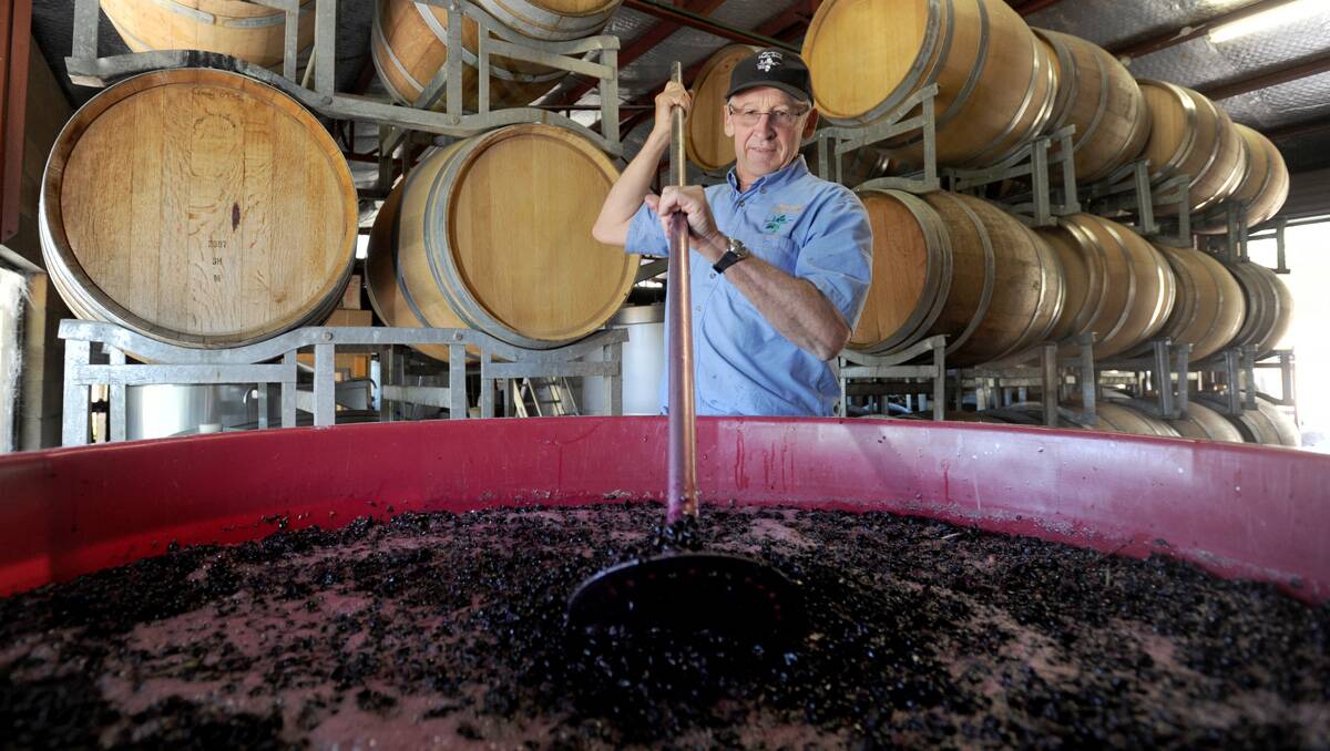 Good year: Wes Vine from Mandurang Valley Wines stirs up a batch of 2013 vintage. Picture: Jodie Donnellan