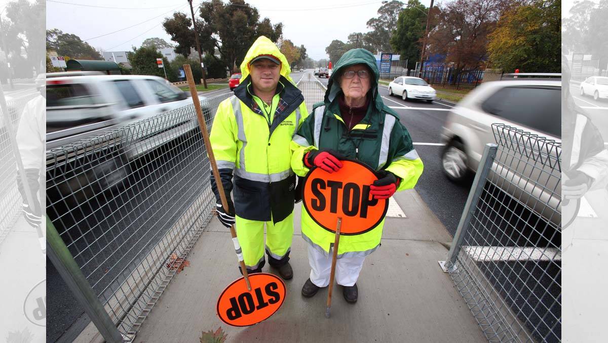 Rain, hail or shine Wayne Ford and Alfreda Davis are working as Crossing Gard Supervisors at St Monicas PS Kangaroo Flat. Picture: Peter Weaving