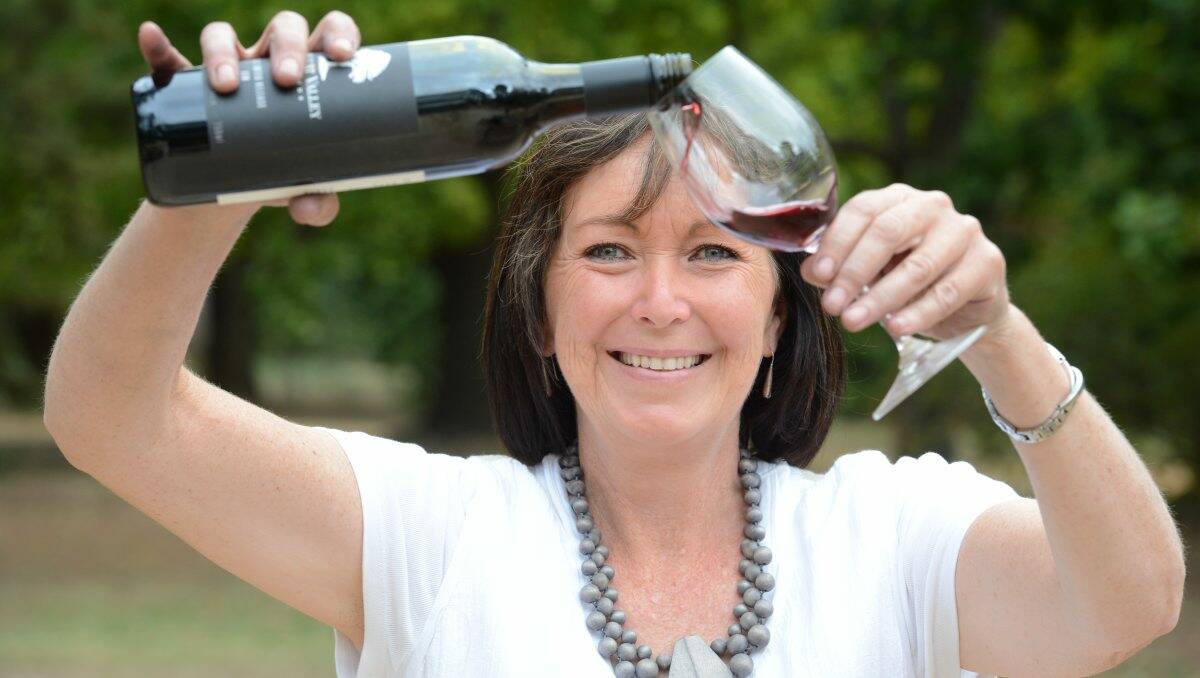 FESTIVE: Castlemaine Food and Wine festival Commitee member Robyn Lougoon from Connor Park winery pours a glass of red wine.  Picture: JIM ALDERSEY