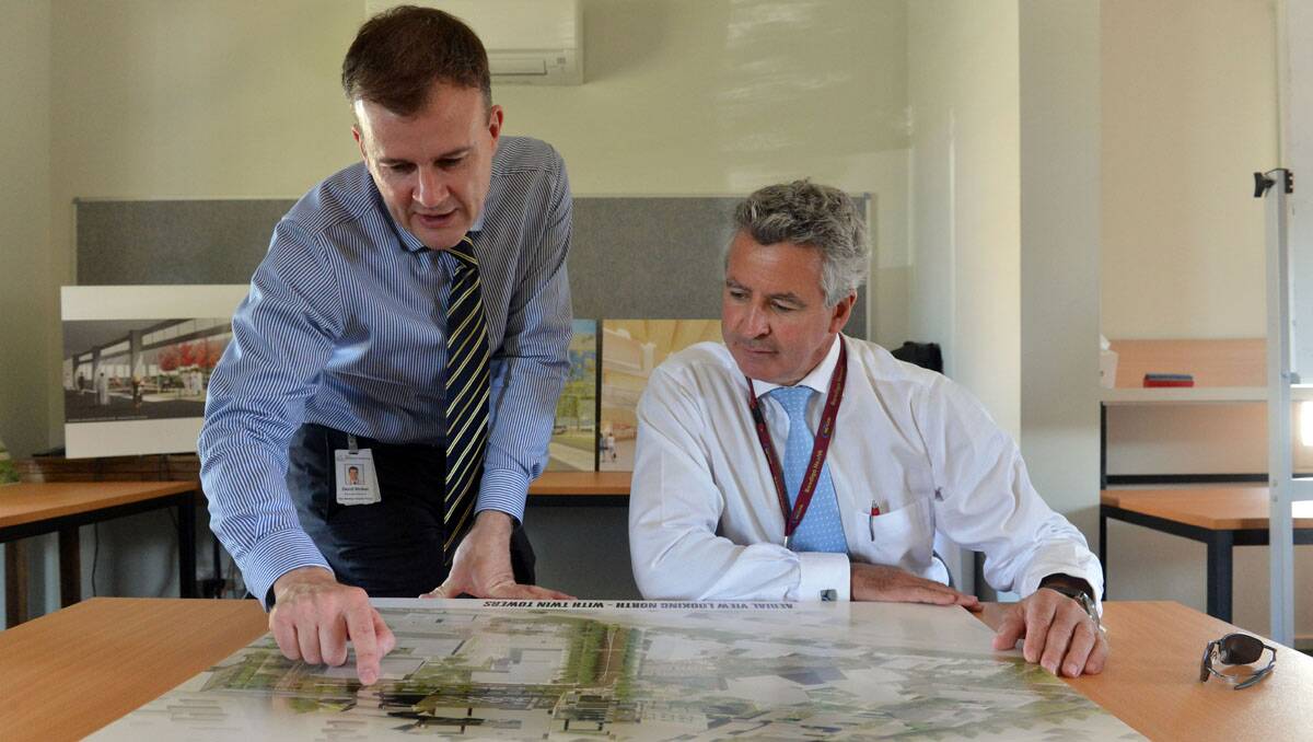 David Walker and John Mulder look over plans for the new Bendigo Hospital. Picture: Brendan McCarthy