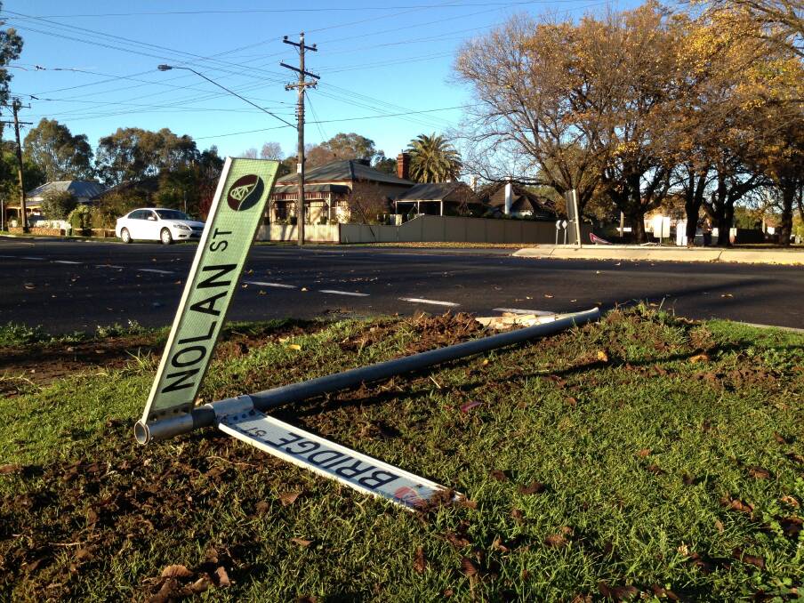 One street sign that was knocked over in the crash. Picture: Josh Fagan